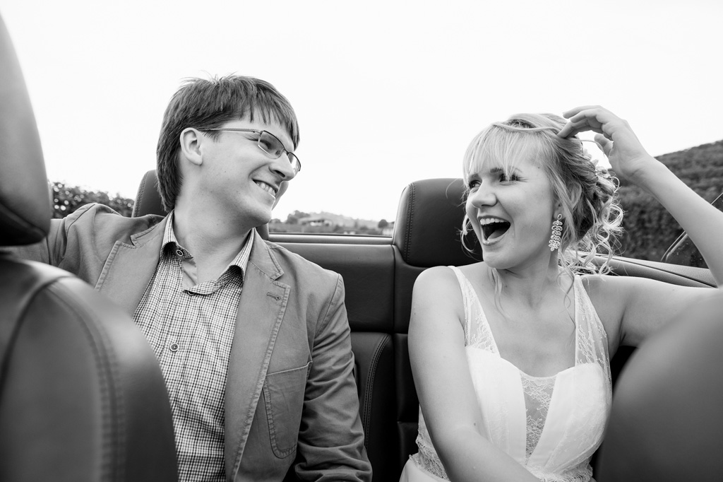 Fotografo Matrimonio Langhe Tatiana ride e scherza in macchina durante il viaggio di destinazione per la cerimonia