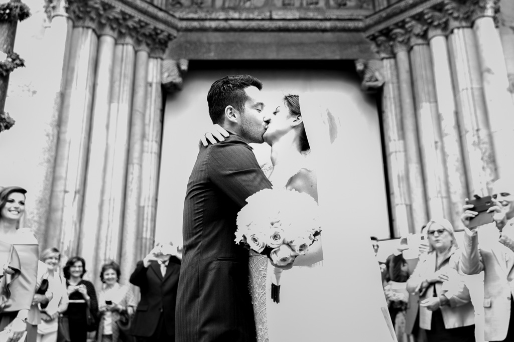 Fotografo Matrimonio Monza I due sposi, Simone e Federica, si baciano tra lo stupore degli invitati