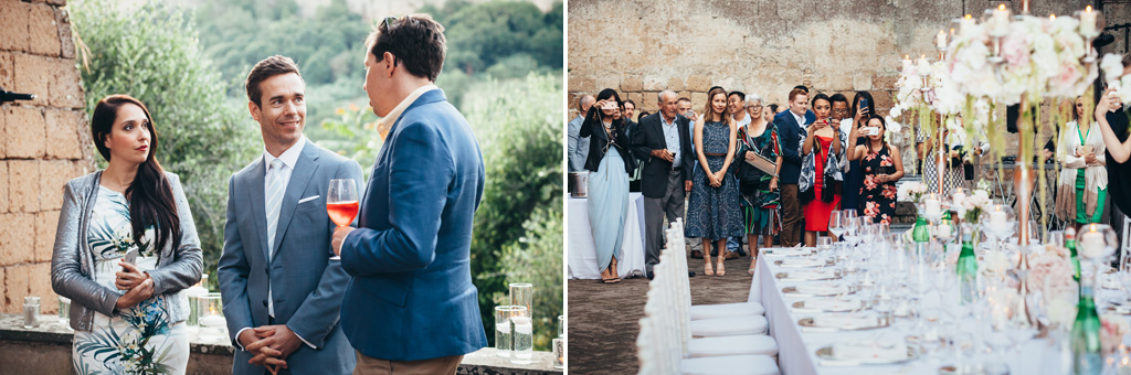 Gli invitati brindano e scattano fotografie alla tavola del ricevimento