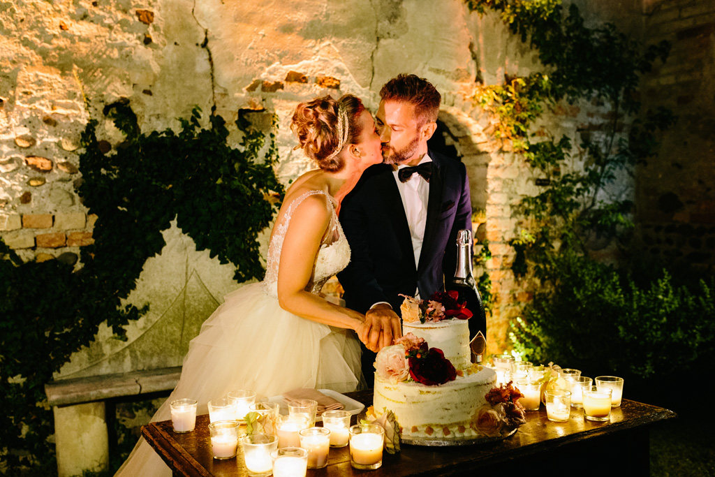 Fotografo Matrimonio Convento Dell'Annunciata Medole Gli sposi si baciano durante il taglio della torta